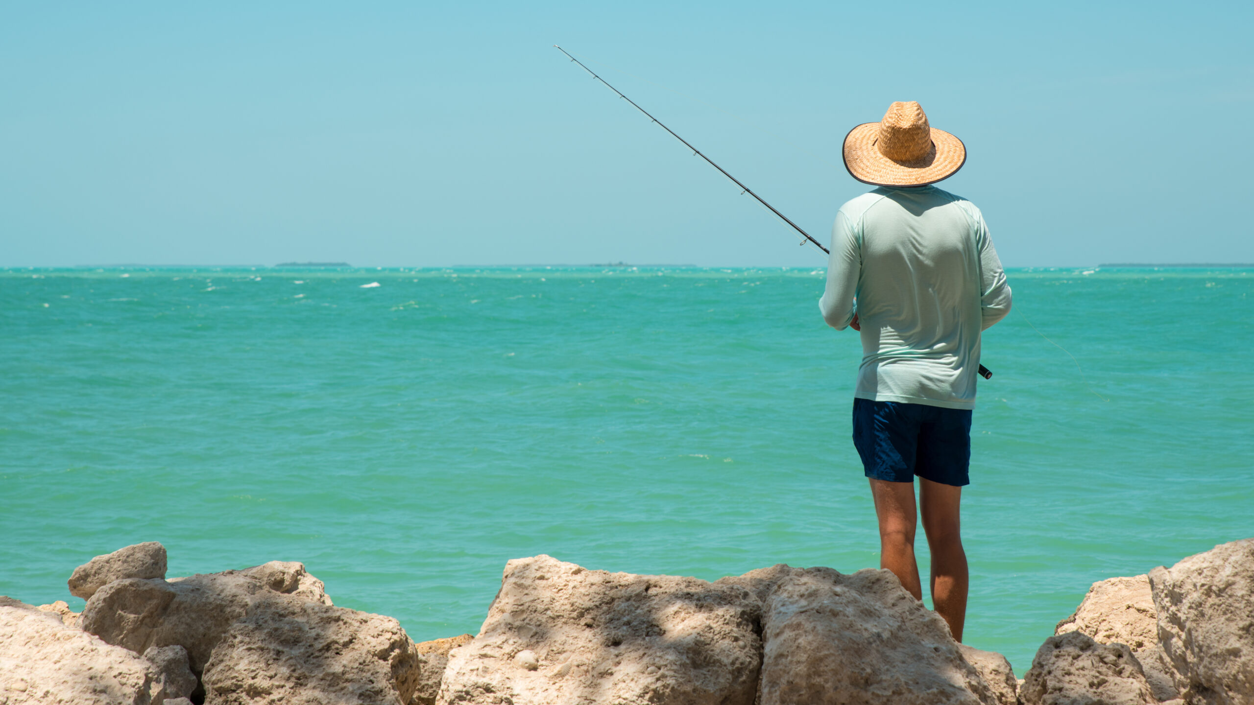 Fisherman with fishing rod. Atlantic ocean or Gulf of Mexico. Sp